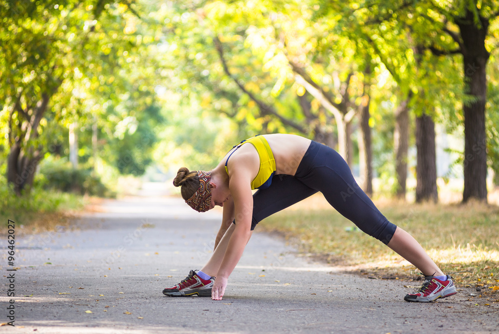 Fitness woman doing streching during outdoor cross training workout Fitness woman doing streching during outdoor cross training workout