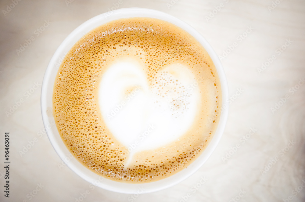 Cup of cappuccino coffee with heart shaped milk foam Cup of cappuccino coffee with heart shaped milk foam