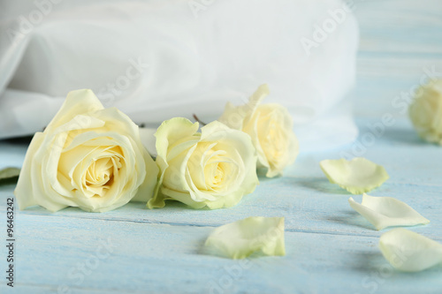 Bouquet of white roses on blue wooden background
