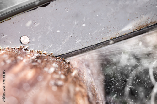 chainsaw blade cutting log of wood