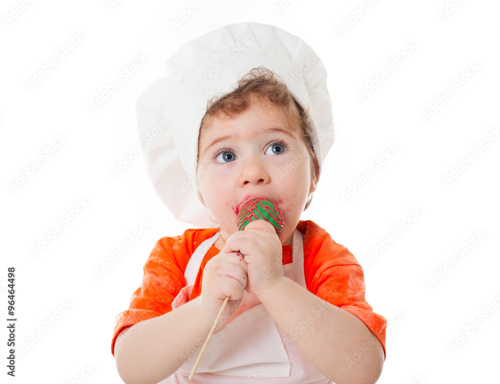 baby chef eating cake pops isolated on white background baby chef eating cake pops isolated on white background