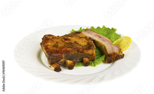 The ribs of wild boar grill on the plate, isolated