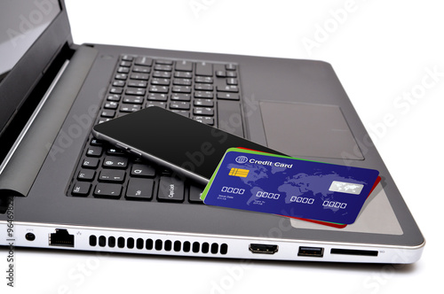 Credit cards and smartphone on keyboard keys