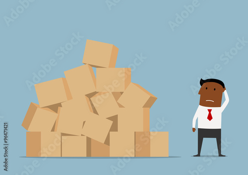 Worried businessman and large pile of boxes