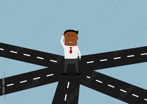 Businessman standing and thinking on crossroad