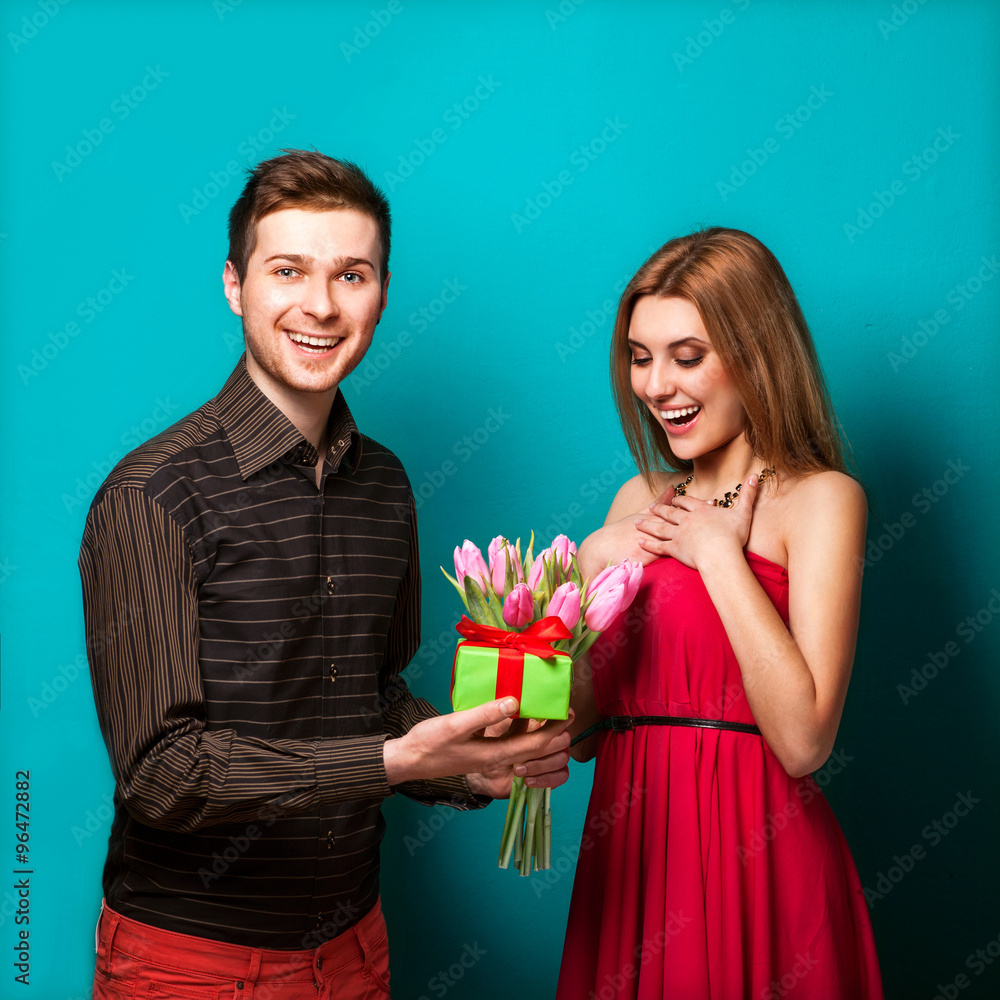 Young couple in love make a heart and hands are holding a bouque Young couple in love make a heart and hands are holding a bouque