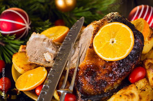 Fototapeta Naklejka Na Ścianę i Meble -  Christmas baked duck served with potatoes, orange and tomatoes