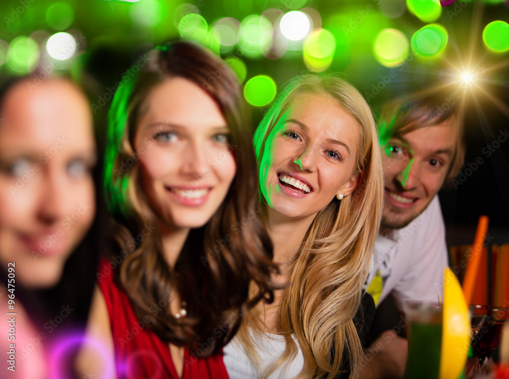 Group of young people having fun in club