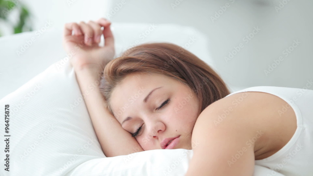 Cute sleeping girl waking up smiling and laughing at camera Cute sleeping girl waking up smiling and laughing at camera