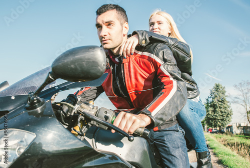 Young couple driving on a sport motorcycle