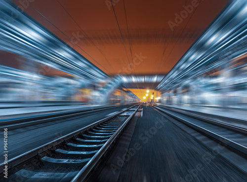 Railway station at night with motion blur effect. Railroad