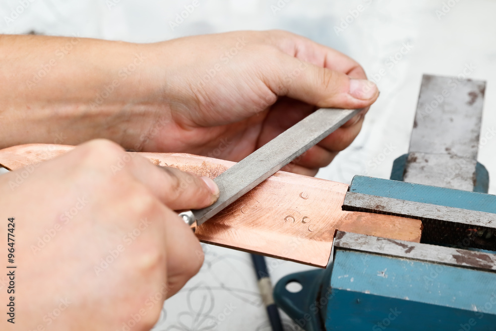 Grinding the copper billet with a file Grinding the copper billet with a file