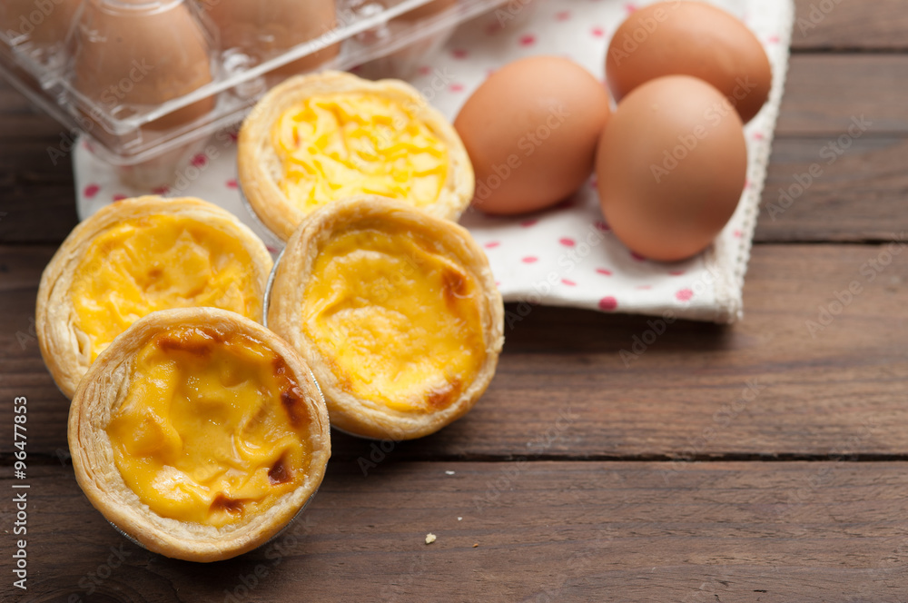 delicious portuguese egg tart on wood background delicious portuguese egg tart on wood background