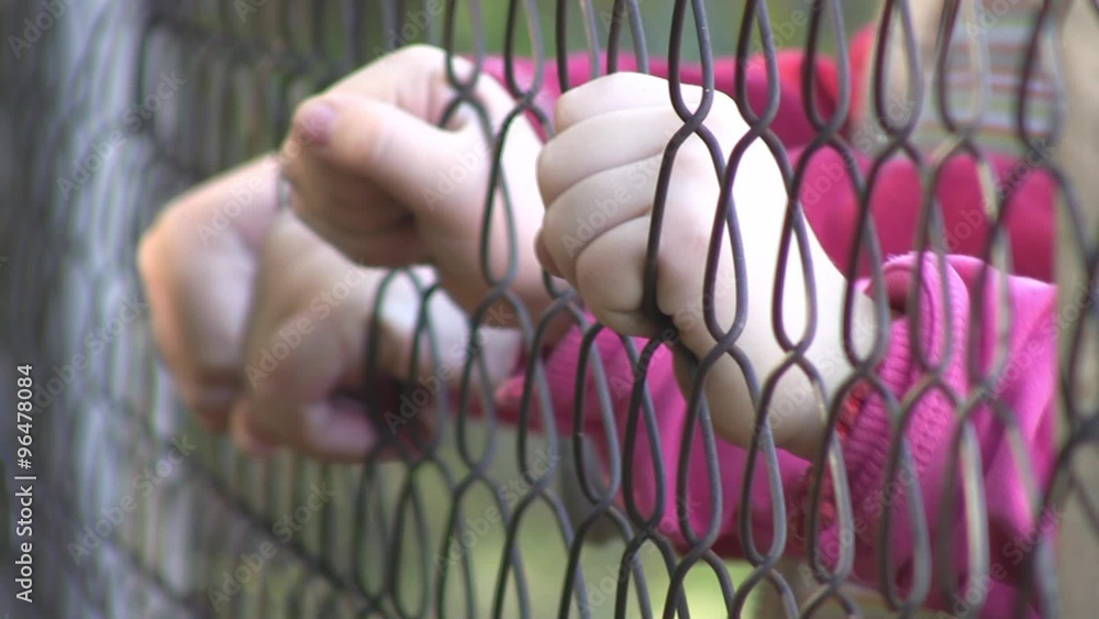 Children hands holding metal fence. Shallow DOF.
Children hands holding metal fence. Shallow DOF.