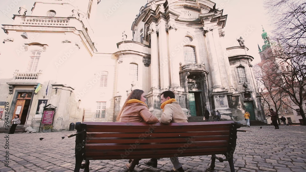 Young couple sit on bench and talk at autumn city
Young couple sit on bench and talk at autumn city