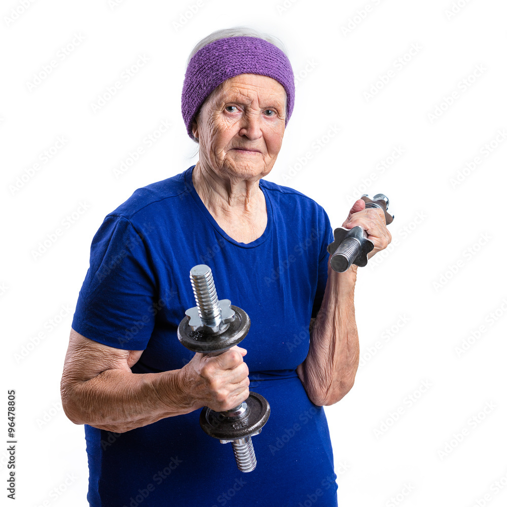 Fototapeta premium Senior woman working out with dumbbells over white background
