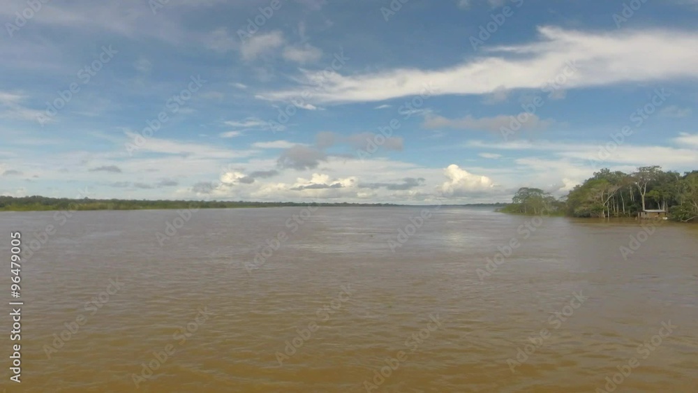 Timelapse front view of the Amazon river and the rain forest with a cloudy blue sky. Amazon States, Brazil Timelapse front view of the Amazon river and the rain forest with a cloudy blue sky. Amazon States, Brazil