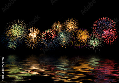 Festive fireworks display with reflections, copy space