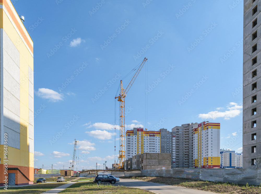 Tower crane on the construction site of a new multi-storey panel house Tower crane on the construction site of a new multi-storey panel house