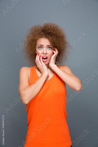 Portrait of scared curly girl photo