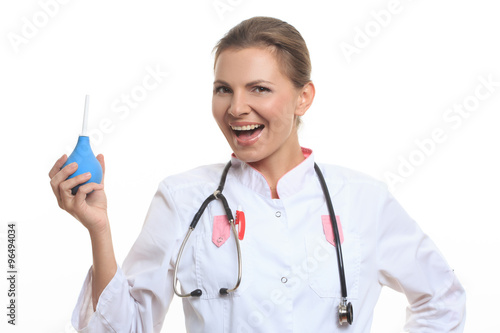 Happy female doctor holding enema photo