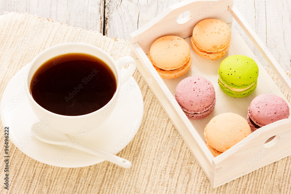 Set of various colored macaroons on wooden plate Set of various colored macaroons on wooden plate