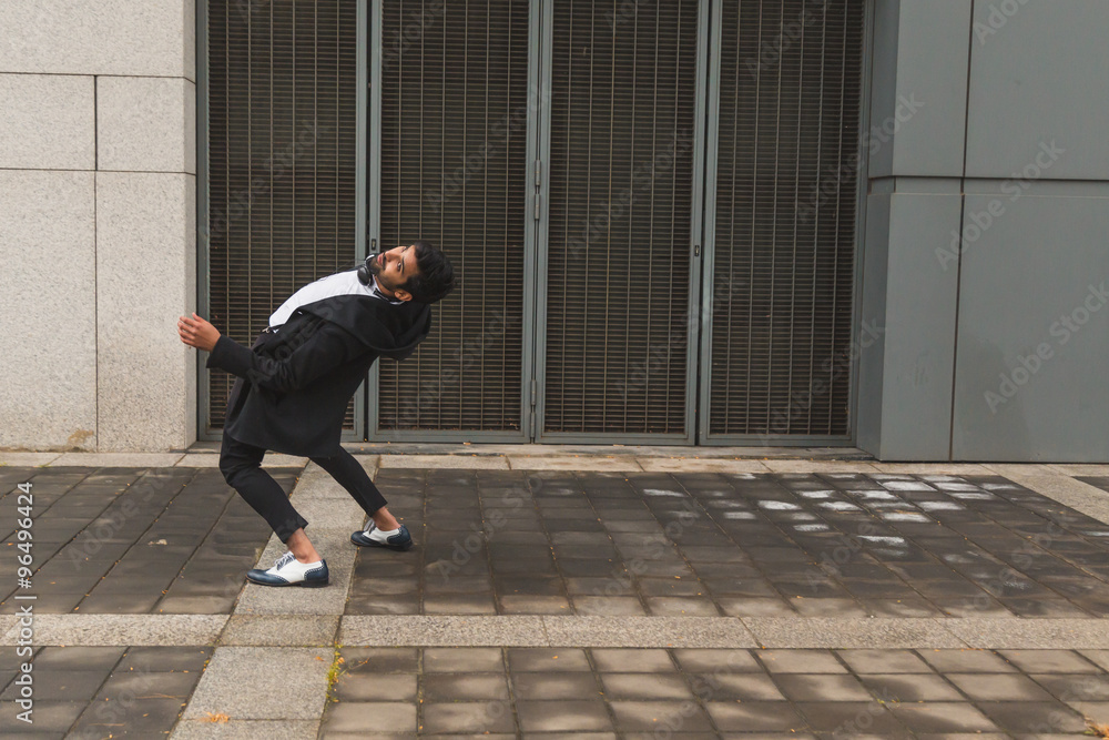 Handsome Indian man posing in an urban context Handsome Indian man posing in an urban context