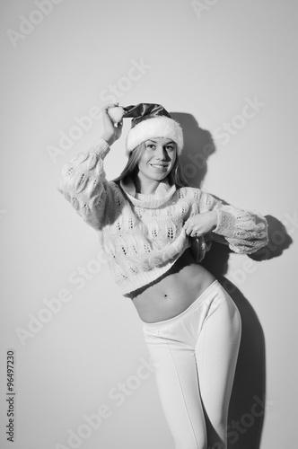 Picture of cheerful pretty girl in santa claus hat posing