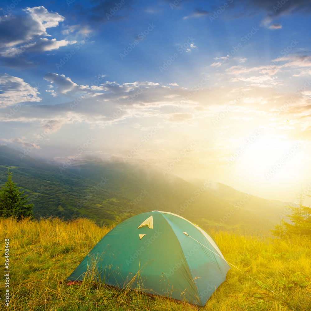 green touristic tent mountain valley sunrise scene