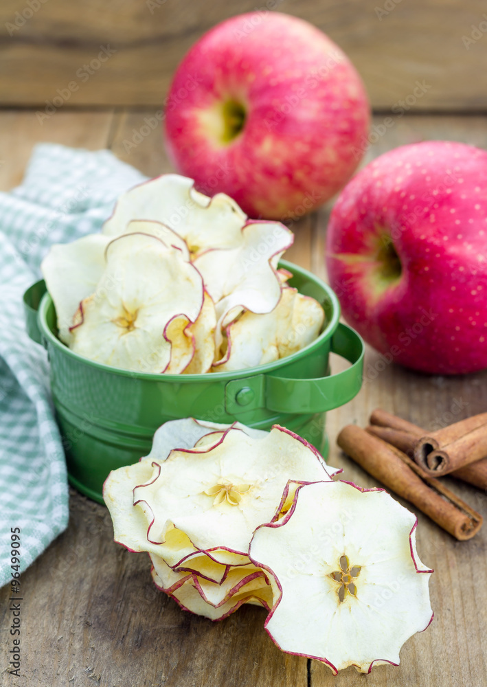 Healthy snack. Homemade apple chips on rustic wooden background