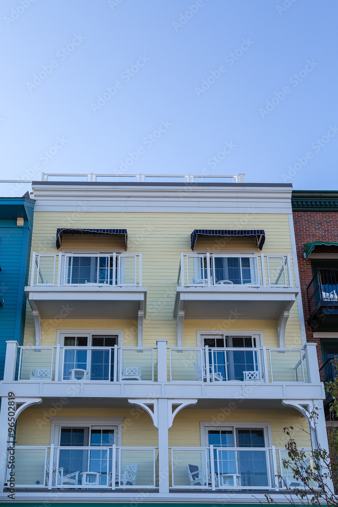 Six White Balconies on Yellow Wood Building