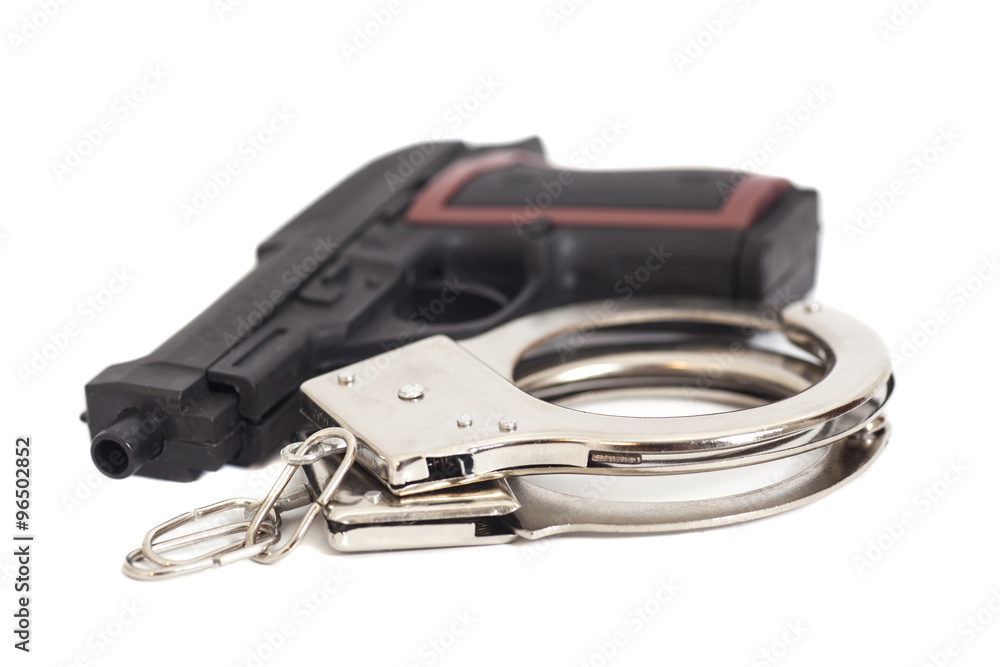 Gun and handcuffs isolated on white background Gun and handcuffs isolated on white background