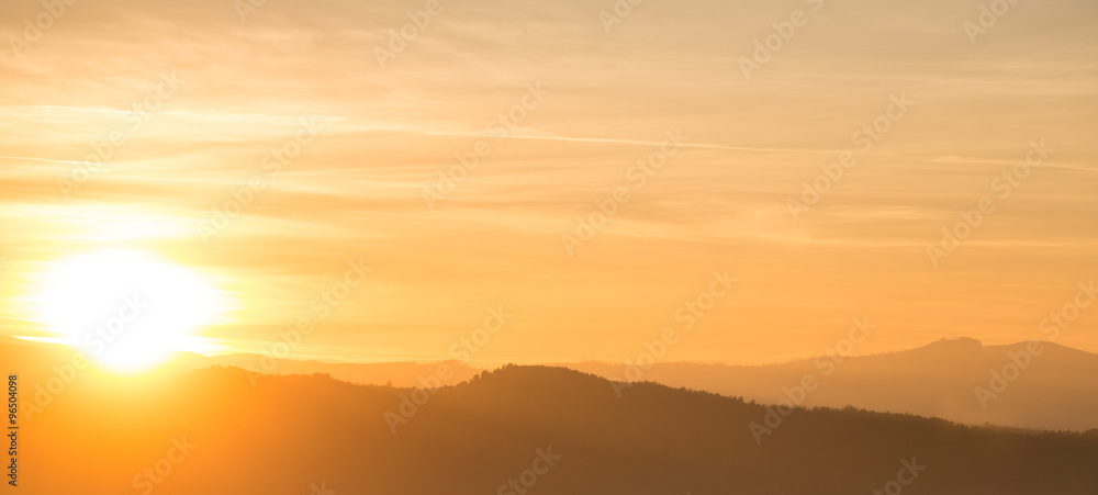 Orange sunset behind mountain range