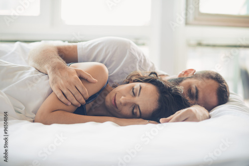 Young man and woman in bed