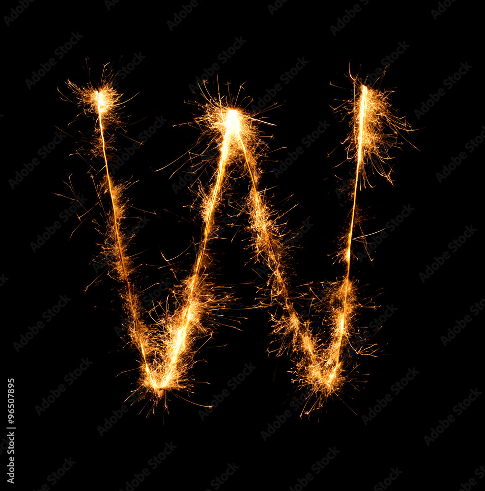 Sparkler firework light alphabet W at night Sparkler firework light alphabet W at night