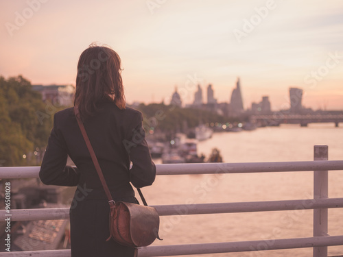 Photography Young woman admiring London at sunrise