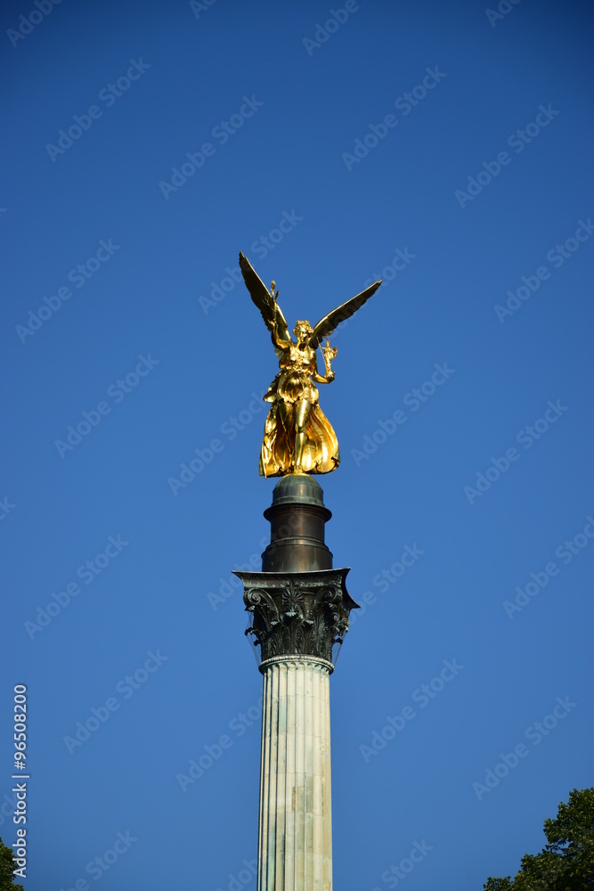 Fototapeta premium MUNICH, GERMANY - Gilded statue featuring a Peace Angel (Friedensengel) on the top of a column