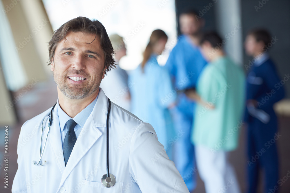 group of medical staff at hospital, handsome doctor in front of group of medical staff at hospital, handsome doctor in front of
