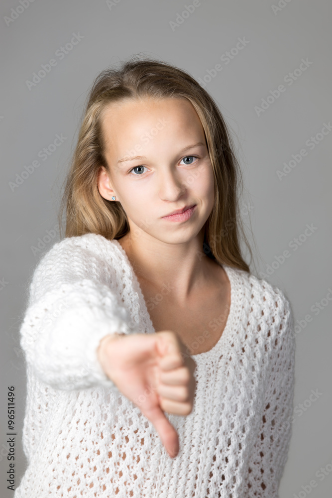 Girl showing dislike sign Girl showing dislike sign