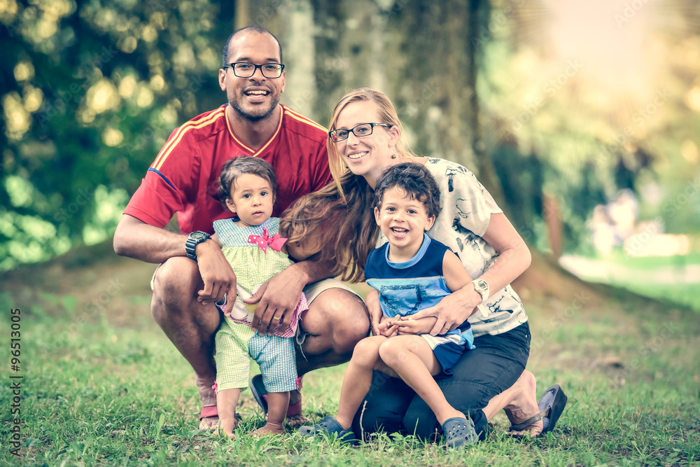 Fototapeta premium Happy interracial family is enjoying a day in the park