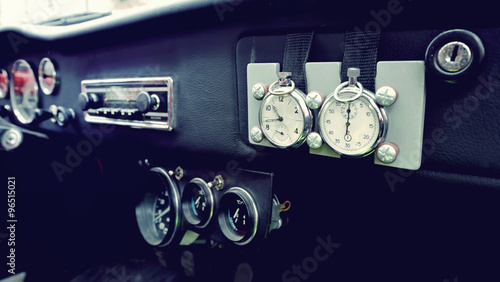 Beautiful original clock on the dashboard in vintage car. Vintag