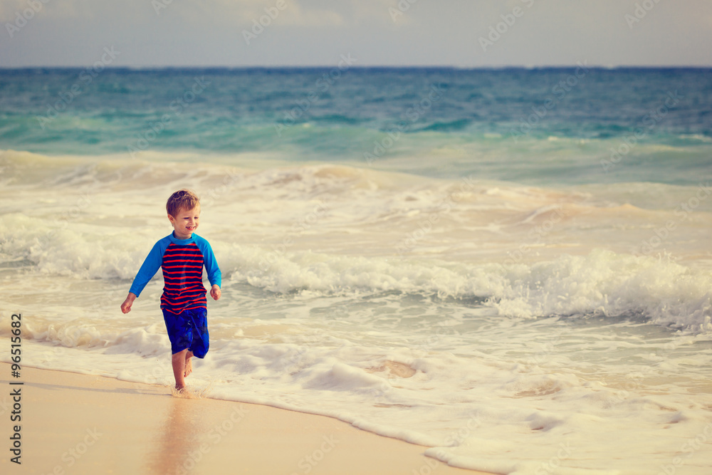 happy little boy running on sand beach happy little boy running on sand beach