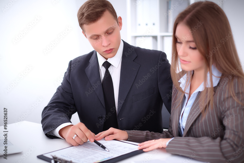 Image of businessman and business woman using clipboard at meeting Image of businessman and business woman using clipboard at meeting