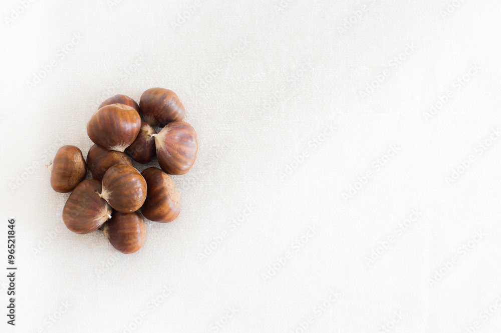 Raw whole brown chestnuts heap