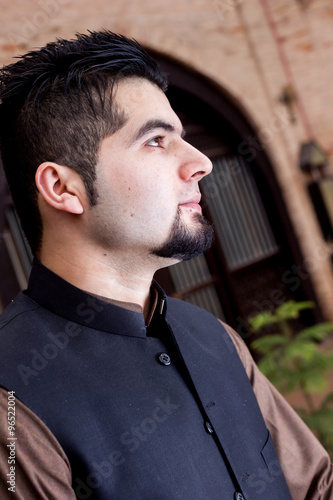 Portrait of young Man in a traditional Pathan dress with modern photo