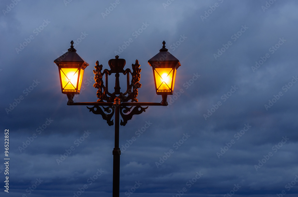 Two street light lantarns on the background of a sky Two street light lantarns on the background of a sky