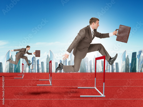 Фотография Men hopping over treadmill barrier with city