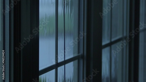 Rain water hitting house windows during thunderstorm