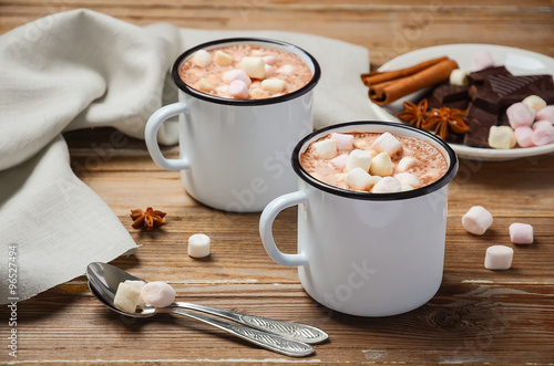 Hot chocolate with marshmallows on the rustic wooden table