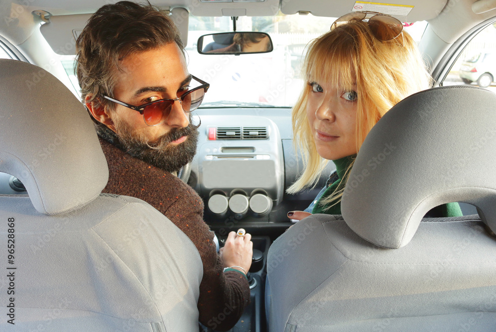 reversing the car, view from back seat young man driving backwards